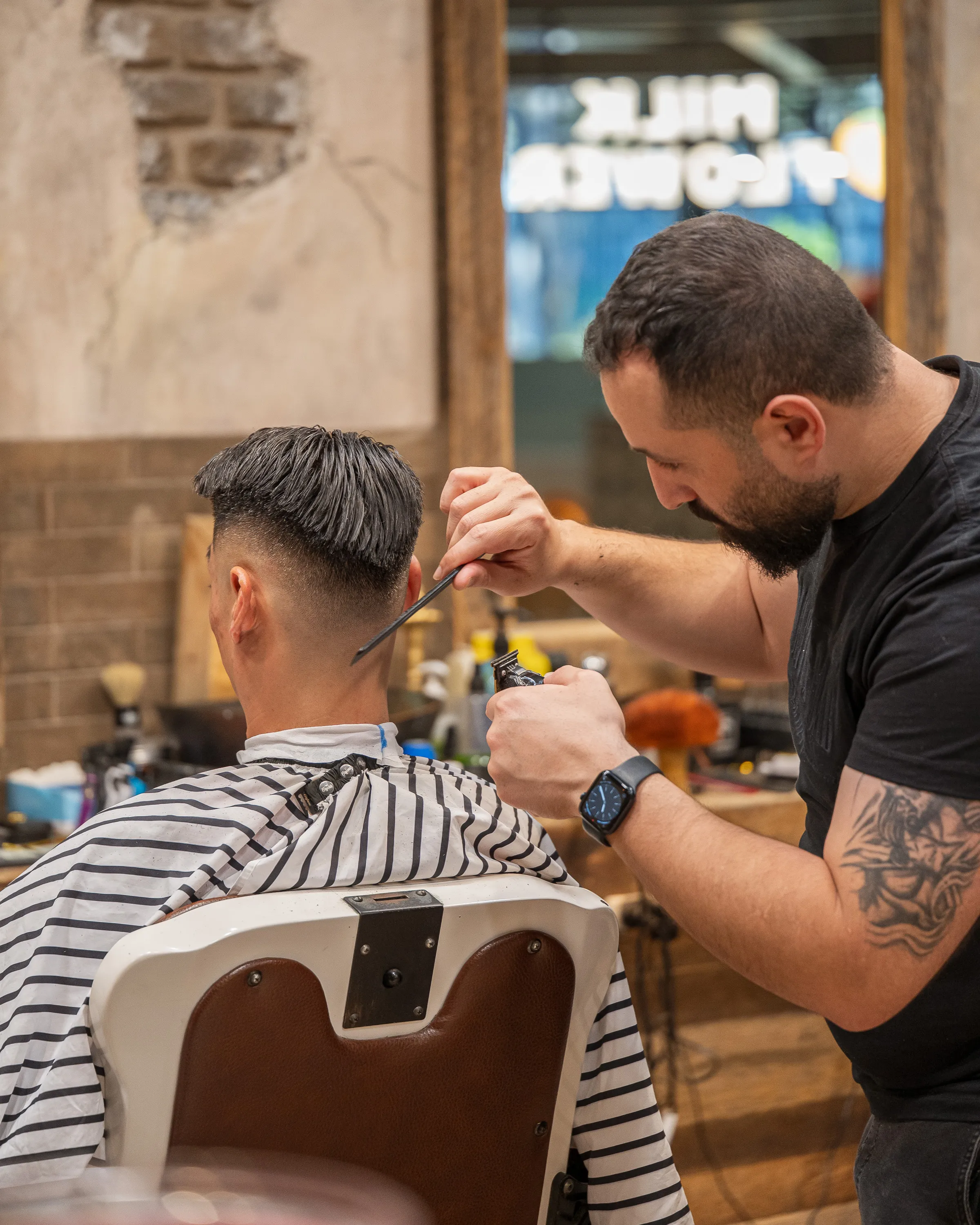 Barber working on a mid fade