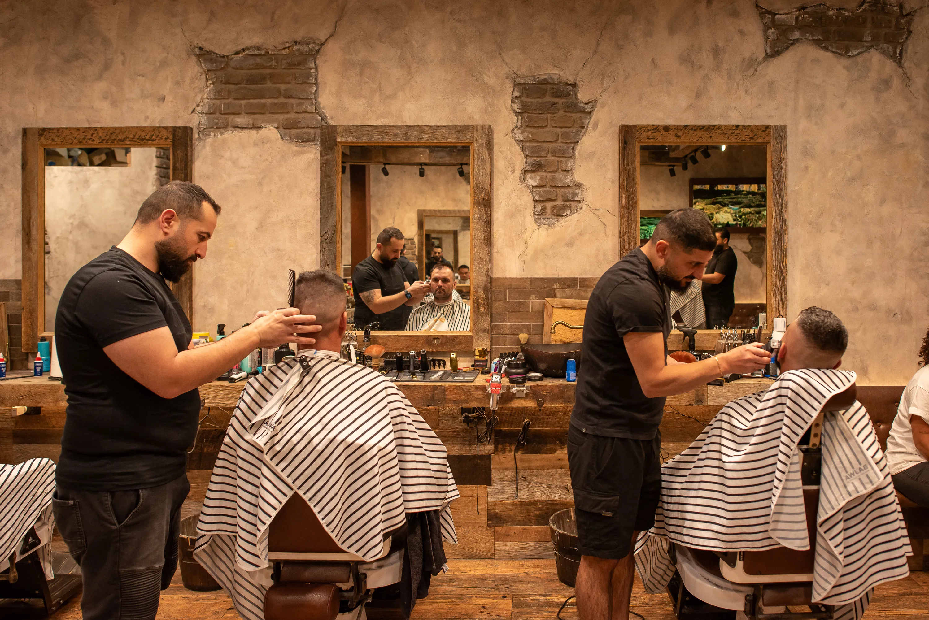 Barbers at work inside Gold Fingers Barber
